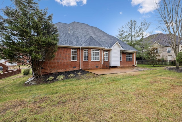 rear view of property featuring a patio area and a lawn