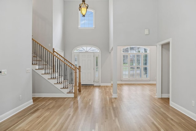 foyer featuring a high ceiling and light wood-type flooring