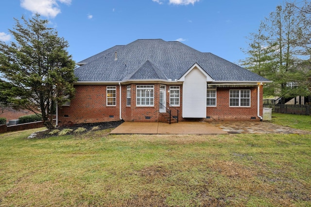 rear view of property featuring a yard and a patio area