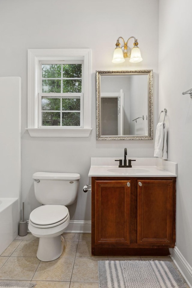 bathroom with vanity, tile patterned floors, a bathtub, and toilet