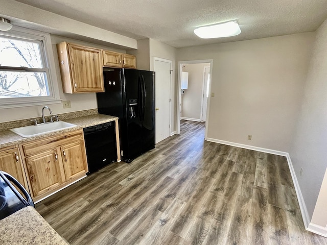 kitchen with dark wood-type flooring, sink, a textured ceiling, and black appliances