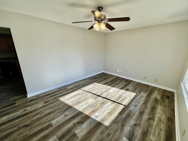 unfurnished room featuring ceiling fan, a textured ceiling, and dark hardwood / wood-style flooring