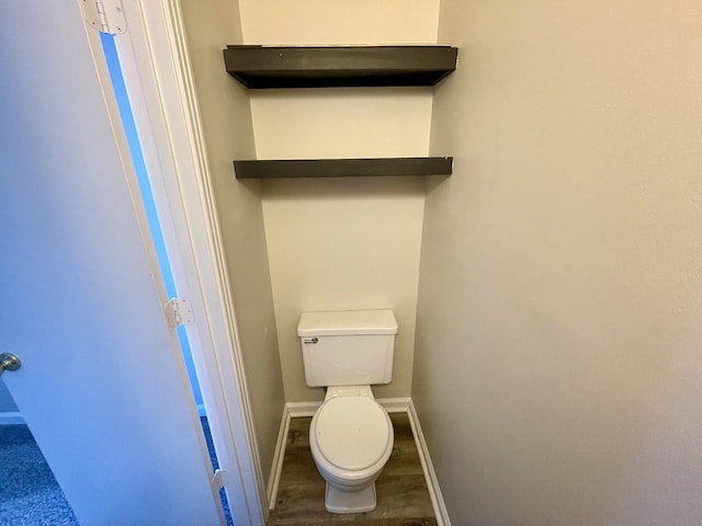 bathroom with toilet and hardwood / wood-style floors