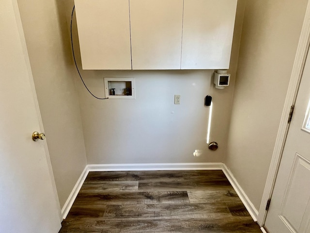 clothes washing area with cabinets, hookup for a washing machine, and dark hardwood / wood-style flooring