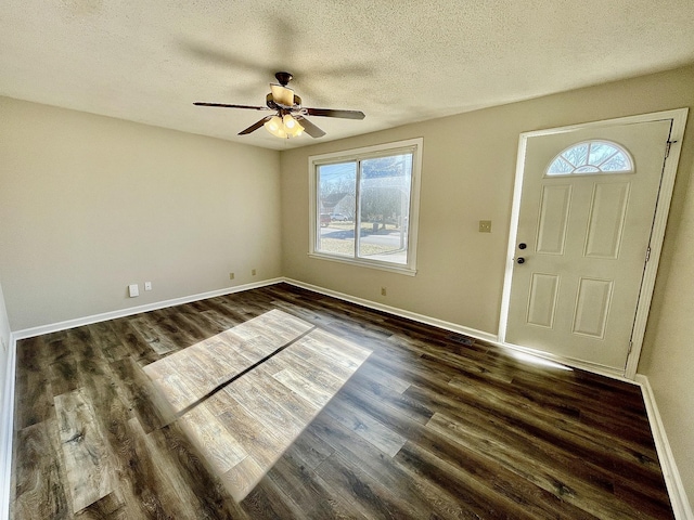 foyer featuring ceiling fan, dark hardwood / wood-style floors, and a textured ceiling