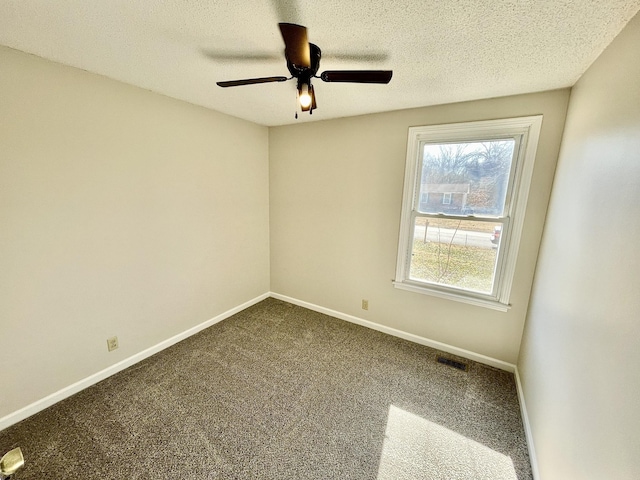 spare room with ceiling fan, carpet floors, and a textured ceiling