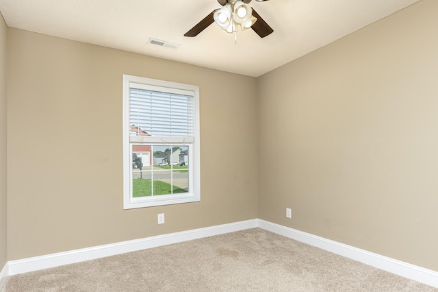 spare room with light carpet and ceiling fan