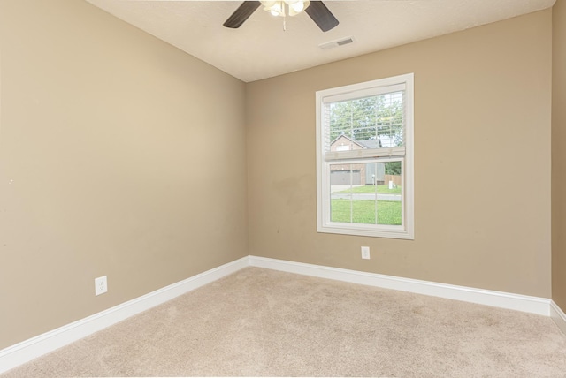 spare room with light colored carpet and ceiling fan