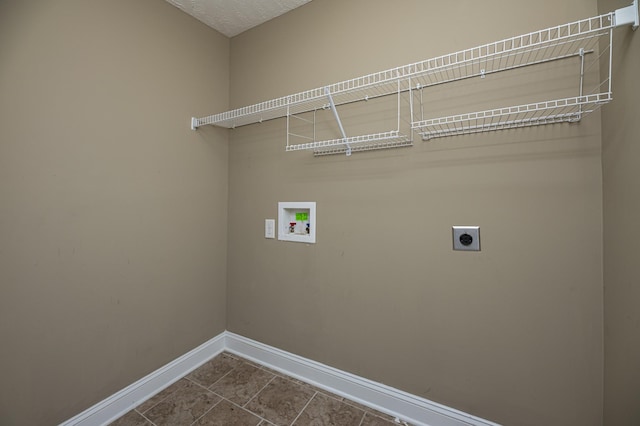 laundry room with tile patterned floors, hookup for a washing machine, a textured ceiling, and electric dryer hookup