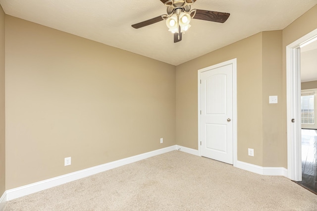 unfurnished bedroom with ceiling fan and carpet