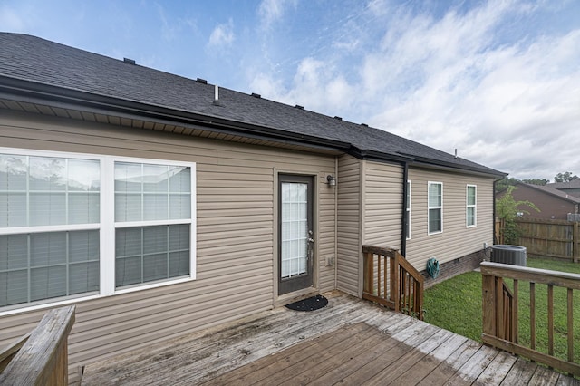 wooden terrace with a yard and central air condition unit