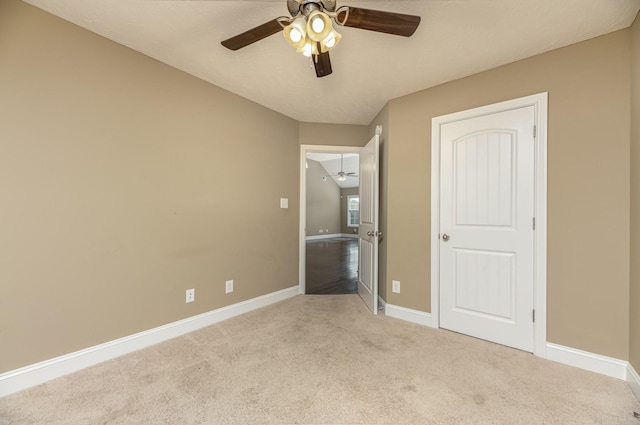 unfurnished bedroom featuring ceiling fan and light colored carpet