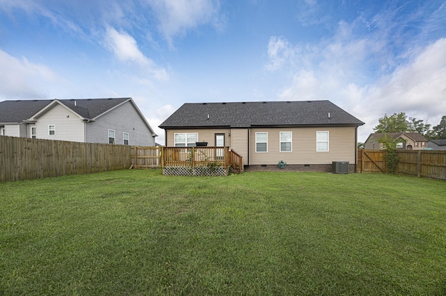 rear view of house with a yard, a deck, and central air condition unit