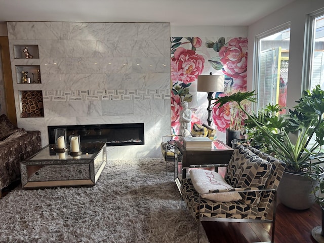 living room with hardwood / wood-style flooring and a high end fireplace