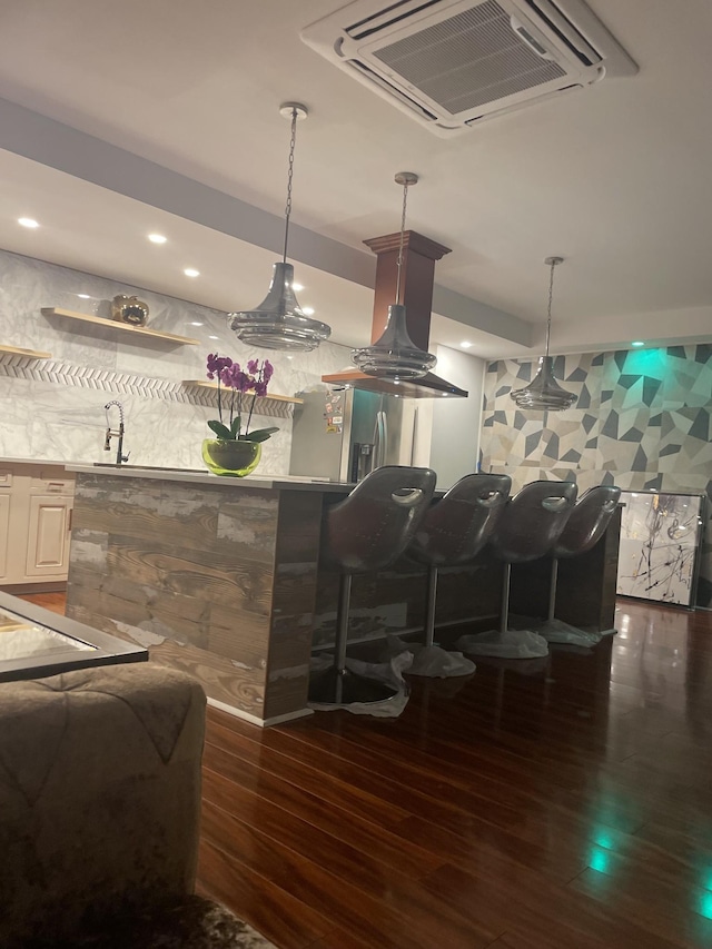 bar with wood finished floors, visible vents, recessed lighting, indoor wet bar, and hanging light fixtures