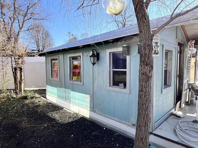 view of home's exterior with fence