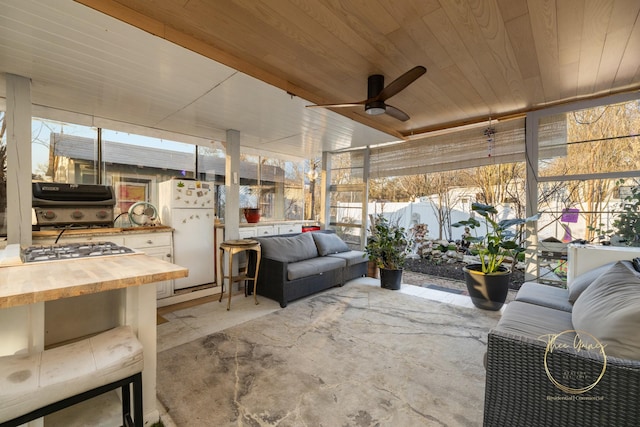 view of patio with fence, an outdoor hangout area, area for grilling, a grill, and a ceiling fan