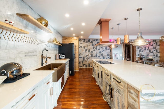 kitchen with open shelves, a sink, dark wood-style floors, freestanding refrigerator, and black electric stovetop