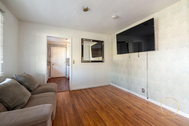 living room with baseboards and wood-type flooring