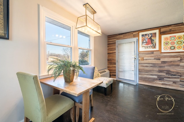 dining space with wood walls