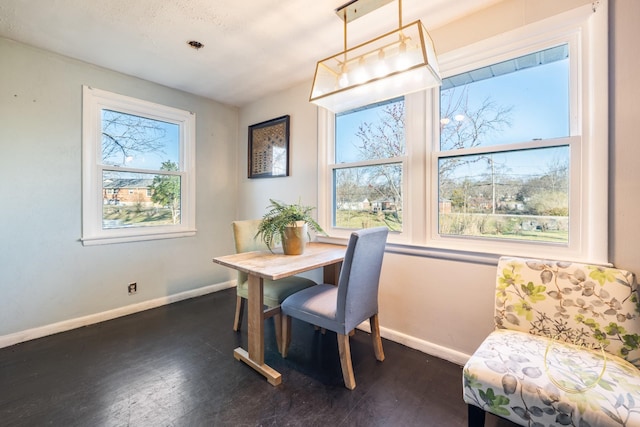 dining room with dark wood-type flooring and baseboards