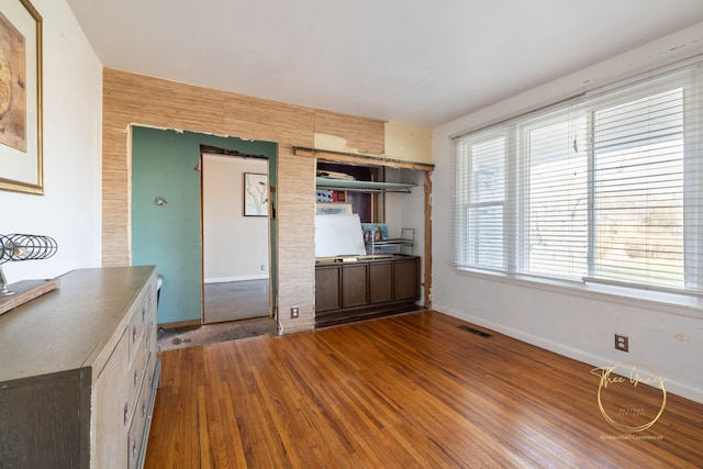 kitchen featuring visible vents, baseboards, and wood finished floors