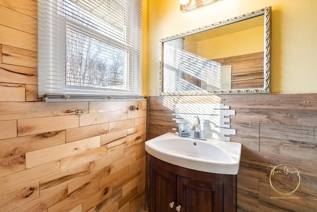 bathroom with vanity and a wainscoted wall