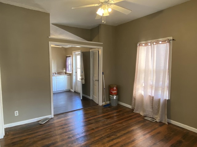 unfurnished room featuring dark hardwood / wood-style floors and ceiling fan