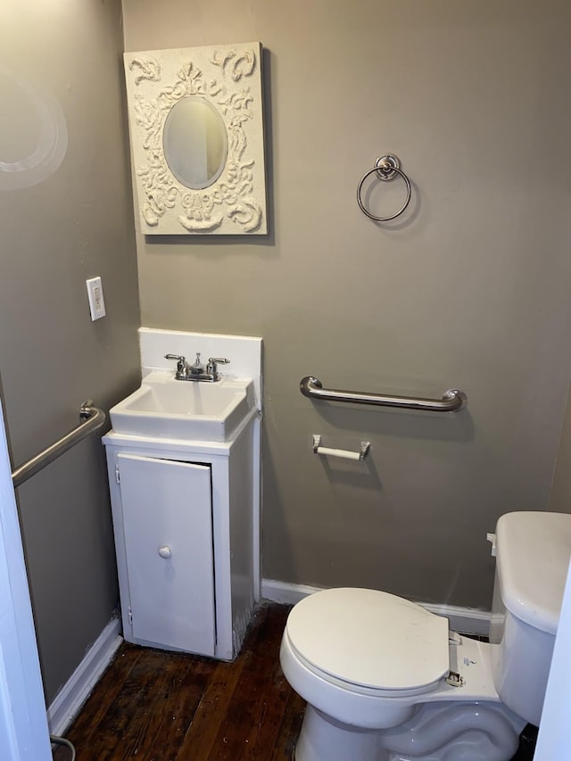 bathroom featuring hardwood / wood-style flooring, vanity, and toilet