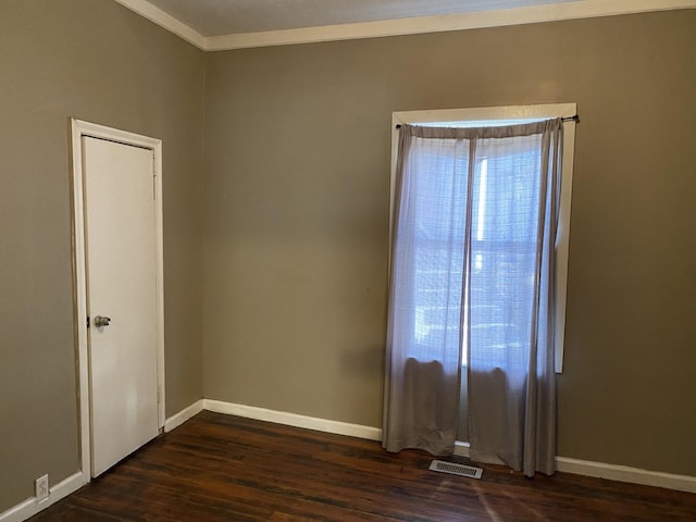 unfurnished room with crown molding and dark hardwood / wood-style floors