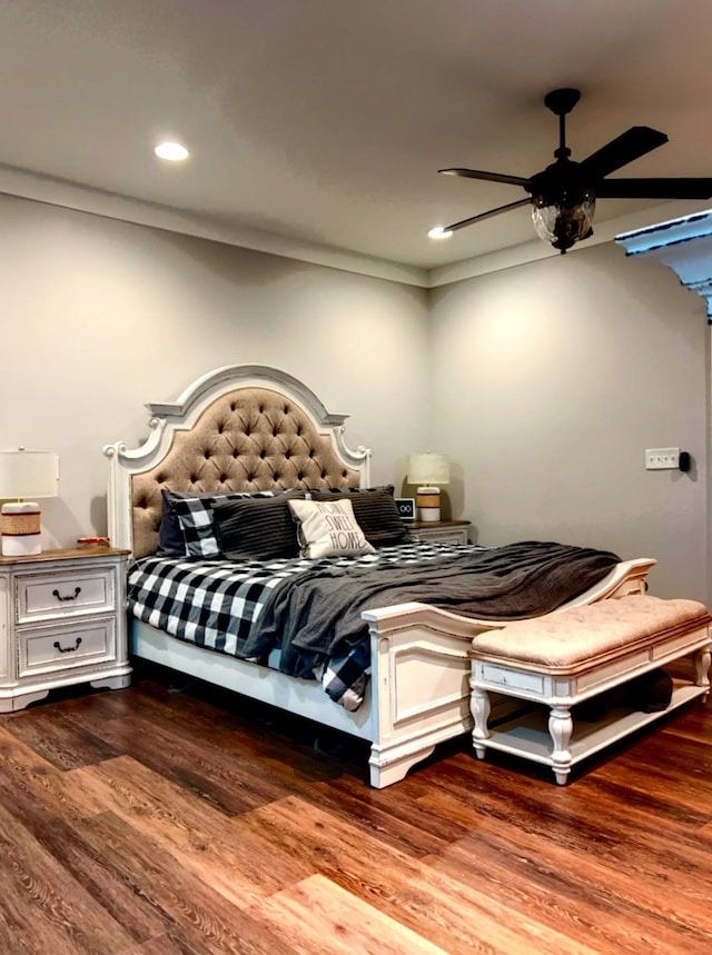 bedroom with ceiling fan, wood-type flooring, and ornamental molding