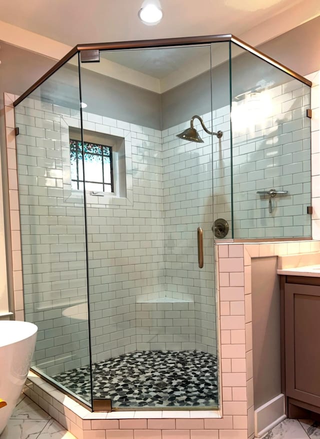 bathroom with vanity and shower with separate bathtub