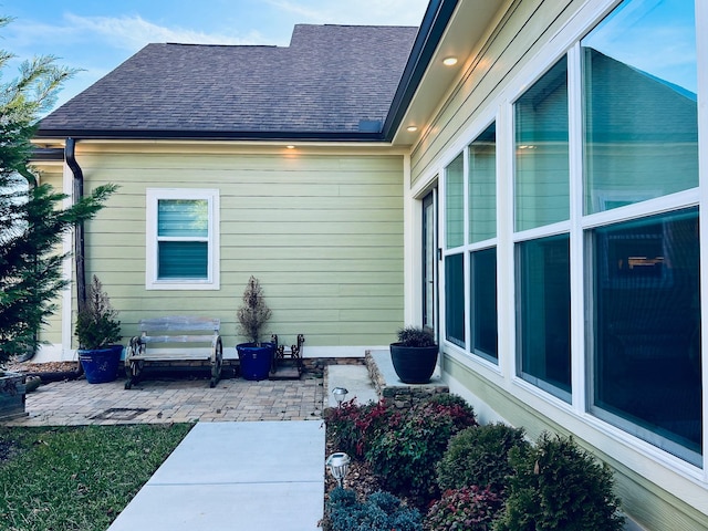 view of property exterior with a patio area