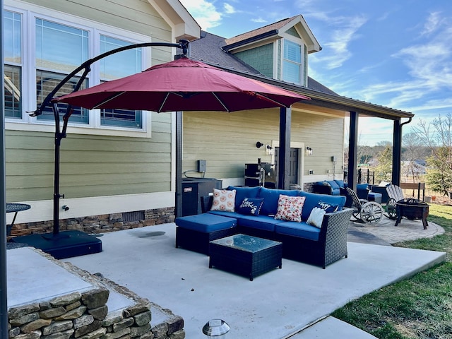 view of patio / terrace featuring an outdoor living space with a fire pit