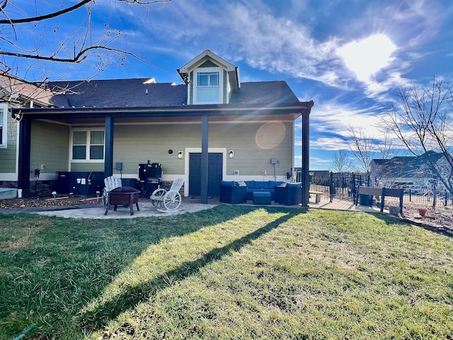 back of house with a yard, a patio, and an outdoor living space with a fire pit