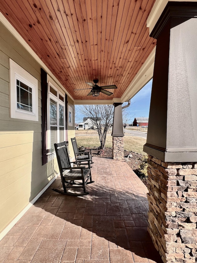 view of patio featuring ceiling fan and a porch