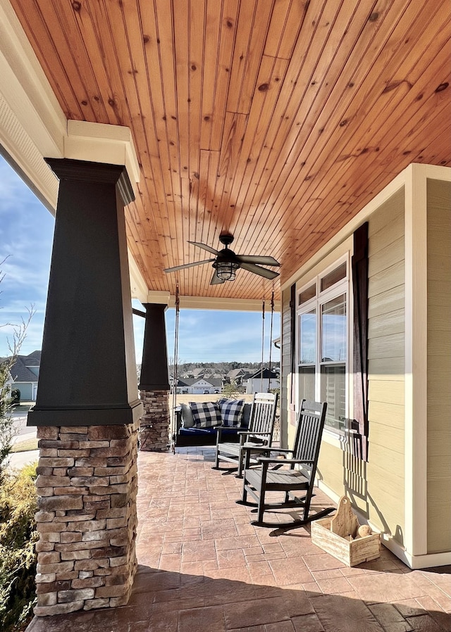 view of patio featuring ceiling fan and a porch