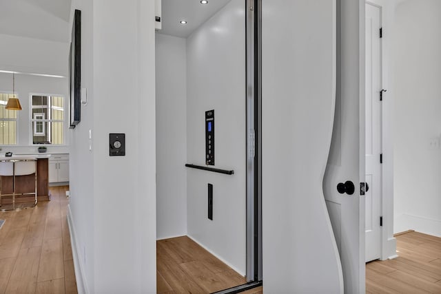 corridor featuring light hardwood / wood-style floors