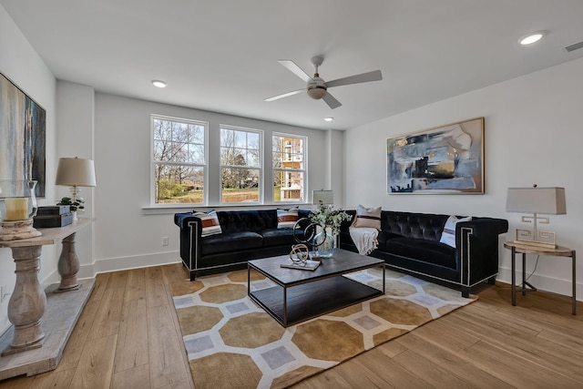 living room featuring ceiling fan and light hardwood / wood-style floors