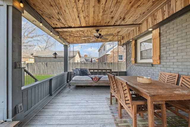 unfurnished sunroom with ceiling fan and wood ceiling