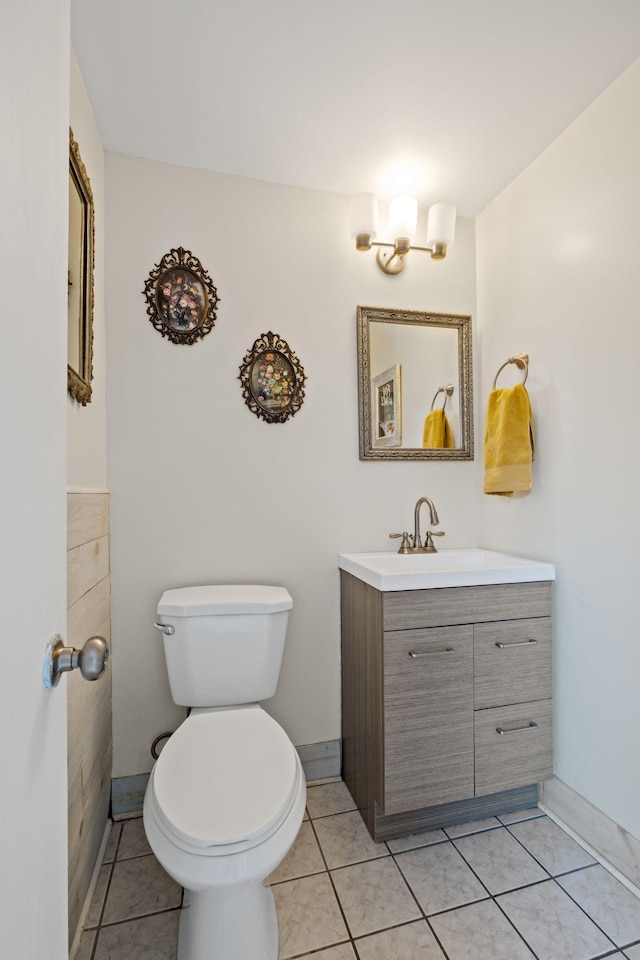 bathroom with tile patterned floors, vanity, and toilet