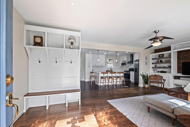 living room with dark hardwood / wood-style floors and ceiling fan