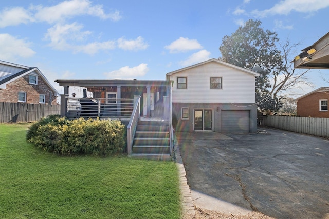 view of front of property featuring a garage and a front yard