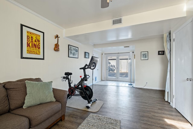 workout area with french doors, ornamental molding, wood-type flooring, and ceiling fan