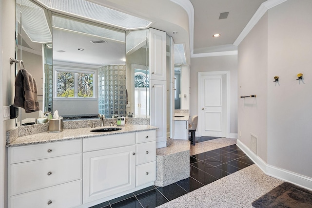 bathroom featuring crown molding and vanity