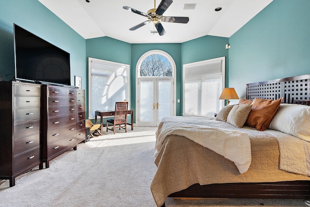 carpeted bedroom featuring multiple windows, vaulted ceiling, and ceiling fan