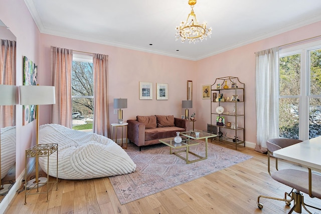 living room featuring ornamental molding, a chandelier, and hardwood / wood-style floors