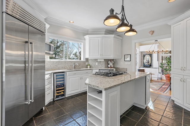 kitchen featuring backsplash, stainless steel appliances, wine cooler, white cabinets, and decorative light fixtures