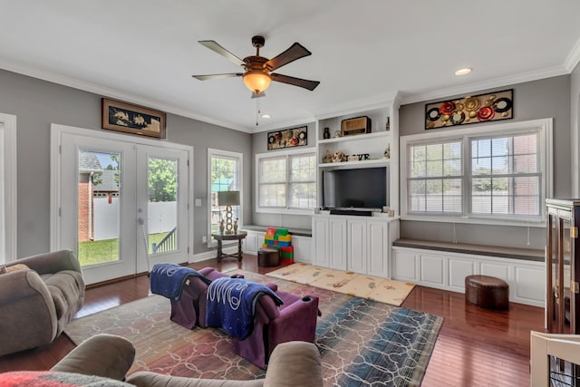 living room featuring french doors, plenty of natural light, crown molding, and dark hardwood / wood-style flooring