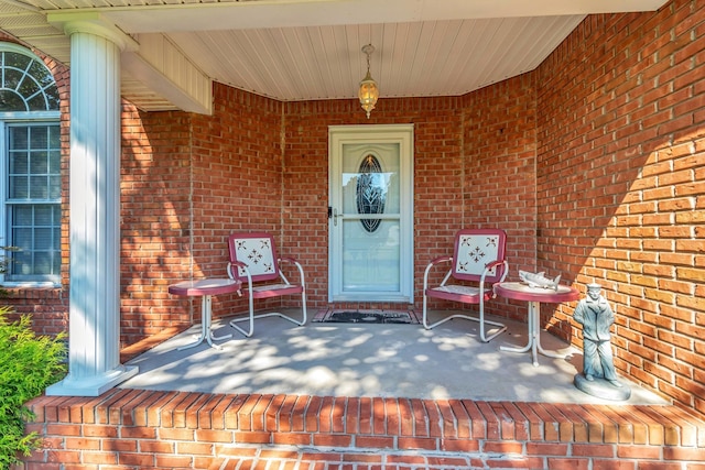 view of exterior entry featuring covered porch